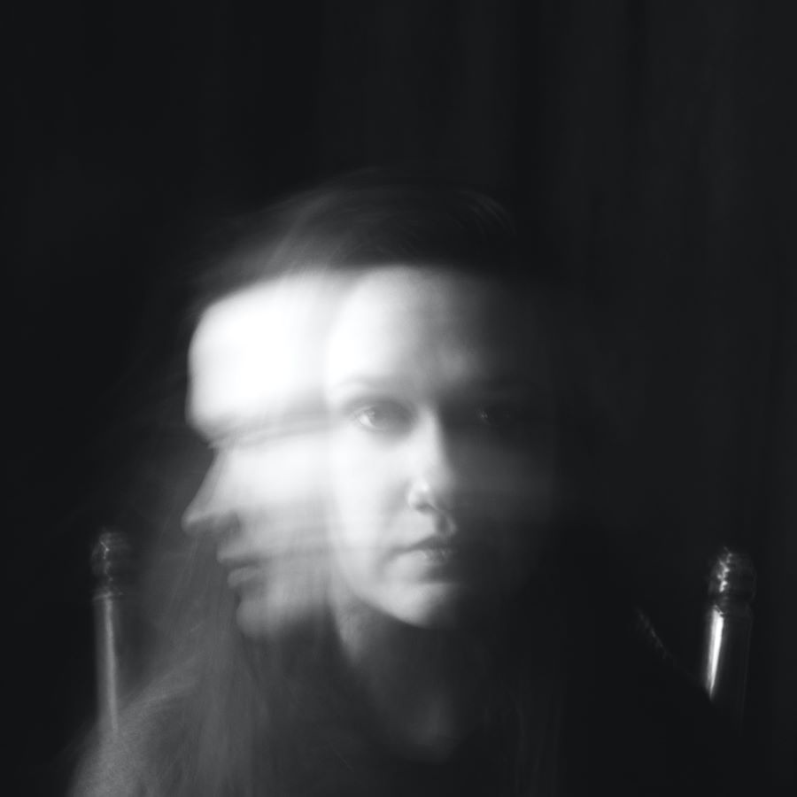 Black and white woman's head shaking in a blur